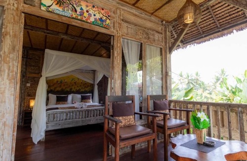 Melayang House | Deluxe room with pool view at Ubud