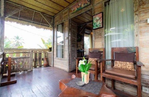 Melayang House | Deluxe room with pool view at Ubud