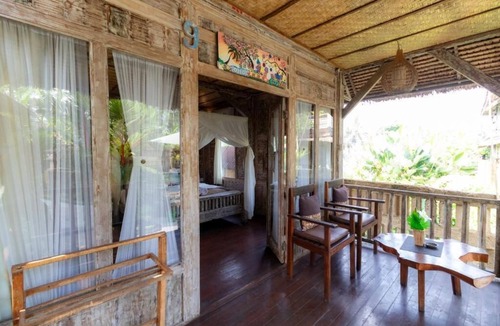 Melayang House | Deluxe room with pool view at Ubud
