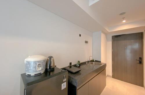 Pagedangan Apartment | Studio Apartment with Sofa at Carstensz Residence By Travelio