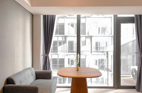 Pagedangan Apartment | Studio Apartment with Sofa at Carstensz Residence By Travelio